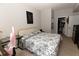 This bedroom has tile floors, a walk-in closet, a desk, and a black and white bed spread at 4008 San Sebastian Dr # 105, Kissimmee, FL 34741