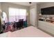 Bedroom with carpeted floors, a closet, a TV, a desk with blinds, and a mirror at 4008 San Sebastian Dr # 105, Kissimmee, FL 34741
