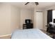 Carpeted bedroom featuring a ceiling fan, a desk, and a dresser at 4008 San Sebastian Dr # 105, Kissimmee, FL 34741