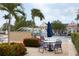 Community pool area with a splash fountain, palm trees, lounge chairs, and a seating area at 4008 San Sebastian Dr # 105, Kissimmee, FL 34741