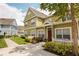 Charming townhome with landscaped front yard and colorful exterior, enhanced by a manicured lawn and inviting walkway at 4008 San Sebastian Dr # 105, Kissimmee, FL 34741