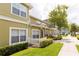 Attractive exterior view of a townhome featuring fresh landscaping and a well-maintained facade at 4008 San Sebastian Dr # 105, Kissimmee, FL 34741