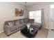 Cozy living room with plush sectional sofa, modern coffee table, and bright window, creating a welcoming atmosphere at 4008 San Sebastian Dr # 105, Kissimmee, FL 34741