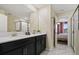 Contemporary bathroom featuring dual sinks, sleek black cabinets, and modern fixtures at 4547 Narrative Ln, Kissimmee, FL 34746