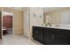 The bathroom features a double sink vanity, black cabinets, and neutral decor at 4547 Narrative Ln, Kissimmee, FL 34746