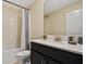 Bright bathroom featuring a single sink vanity and shower-tub combination at 4547 Narrative Ln, Kissimmee, FL 34746