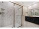 Bright bathroom with a glass-enclosed shower, sleek black cabinets, and tile flooring at 4547 Narrative Ln, Kissimmee, FL 34746