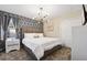 Modern bedroom with geometric wallpaper, stylish lighting, and plush king-size bed at 4547 Narrative Ln, Kissimmee, FL 34746