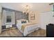Comfortable bedroom featuring patterned wallpaper and a stylish, decorative overhead light at 4547 Narrative Ln, Kissimmee, FL 34746