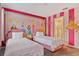 bedroom showcases pink striped walls, princess decor, and twin beds at 4547 Narrative Ln, Kissimmee, FL 34746