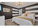 This bedroom features modern lighting and contemporary striped walls, creating a stylish and inviting space at 4547 Narrative Ln, Kissimmee, FL 34746