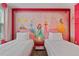 Themed bedroom with princess wall art and two pink twin beds at 4547 Narrative Ln, Kissimmee, FL 34746
