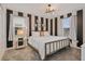 Bright bedroom with a metal frame bed and black and white stripped accent wall, creating a modern style at 4547 Narrative Ln, Kissimmee, FL 34746