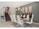 Dining room featuring modern table, chairs, lighting fixture, and stairs at 4547 Narrative Ln, Kissimmee, FL 34746