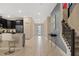 Bright foyer with marble floors, staircase, and sleek console table at 4547 Narrative Ln, Kissimmee, FL 34746
