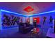 Unique game room with superhero-themed decorations, ambient lighting, and entertainment amenities at 4547 Narrative Ln, Kissimmee, FL 34746