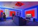 Amusing game room adorned with superhero decorations, vibrant lighting, and recreation options at 4547 Narrative Ln, Kissimmee, FL 34746