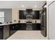 Modern kitchen featuring stainless steel appliances and sleek black cabinetry at 4547 Narrative Ln, Kissimmee, FL 34746