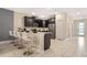 Eat-in kitchen featuring modern appliances, marble floors, and sleek breakfast bar at 4547 Narrative Ln, Kissimmee, FL 34746
