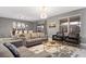 Open-concept living area with stylish furniture, a dining table, and modern decor, great for entertaining at 4547 Narrative Ln, Kissimmee, FL 34746