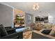 Open-concept space with a living area and kitchen, featuring modern furniture and stylish decor at 4547 Narrative Ln, Kissimmee, FL 34746