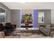 Well-lit living room showcasing contemporary furniture, a unique TV wall, and a cozy atmosphere at 4547 Narrative Ln, Kissimmee, FL 34746