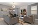 Cozy living room featuring two plush sofas, modern lighting, and a wall-mounted TV for entertainment at 4547 Narrative Ln, Kissimmee, FL 34746