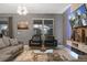 Comfortable living room with elegant furniture, a large window for natural light, and a modern TV setup at 4547 Narrative Ln, Kissimmee, FL 34746