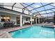 Stunning screened pool area with a pristine pool, integrated spa, and ample seating for relaxation and entertaining at 4547 Narrative Ln, Kissimmee, FL 34746