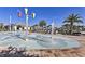 Community splash pad with colorful water features and surrounding lounge chairs at 4547 Narrative Ln, Kissimmee, FL 34746