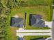 Aerial view showcasing two houses with green lawns and modern driveways at 536 Bristol Cir, Kissimmee, FL 34758