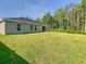 Spacious backyard featuring a well-maintained lawn and lush trees at 536 Bristol Cir, Kissimmee, FL 34758