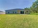 Expansive backyard with a serene view and sliding glass doors to the patio at 536 Bristol Cir, Kissimmee, FL 34758