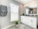 Bright bathroom featuring a shower, vanity with drawers, and soft natural lighting at 536 Bristol Cir, Kissimmee, FL 34758