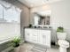Bright bathroom with granite vanity, a window, and ample cabinet storage space at 536 Bristol Cir, Kissimmee, FL 34758