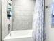 Bathroom featuring a bathtub, shower curtain, tiled walls, and towel rack at 536 Bristol Cir, Kissimmee, FL 34758