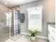 The bathroom features a glass-enclosed shower and a white vanity with ample storage at 536 Bristol Cir, Kissimmee, FL 34758