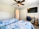 Bedroom with two twin beds, ceiling fan, desk, and closet space at 536 Bristol Cir, Kissimmee, FL 34758