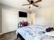 Bedroom with ceiling fan, mounted TV, closet, desk and a doorway to another room at 536 Bristol Cir, Kissimmee, FL 34758