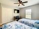 This bedroom has two twin beds, a ceiling fan, window, closet and a desk at 536 Bristol Cir, Kissimmee, FL 34758