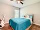 Comfortable bedroom with a window, a bed with blue comforter, and exercise equipment at 536 Bristol Cir, Kissimmee, FL 34758