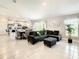 Open floor plan blending the living room and dining areas, featuring ceramic tile and modern decor at 536 Bristol Cir, Kissimmee, FL 34758
