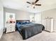 Spacious main bedroom features white dressers, ceiling fan, and soft carpeting at 536 Bristol Cir, Kissimmee, FL 34758