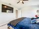 Comfortable main bedroom with ceiling fan, wall-mounted TV, and ensuite bathroom at 536 Bristol Cir, Kissimmee, FL 34758