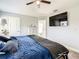 Comfortable main bedroom with mounted television and ensuite bathroom for ultimate convenience at 536 Bristol Cir, Kissimmee, FL 34758