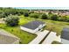 Aerial view of a home with a large driveway, lush yard, and serene surroundings at 547 Viceroy Ct, Kissimmee, FL 34758