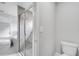 Modern bathroom features a tiled walk-in shower with glass door and a toilet at 547 Viceroy Ct, Kissimmee, FL 34758