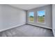 Bright bedroom with dual windows, carpet, and a soothing ambiance perfect for relaxation and rest at 547 Viceroy Ct, Kissimmee, FL 34758