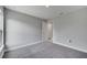 Carpeted bedroom boasts gray walls, natural light, electrical outlets, and a view into the hall at 547 Viceroy Ct, Kissimmee, FL 34758