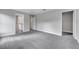 Spacious bedroom with neutral gray walls, plush carpeting, leading into the en-suite bathroom at 547 Viceroy Ct, Kissimmee, FL 34758